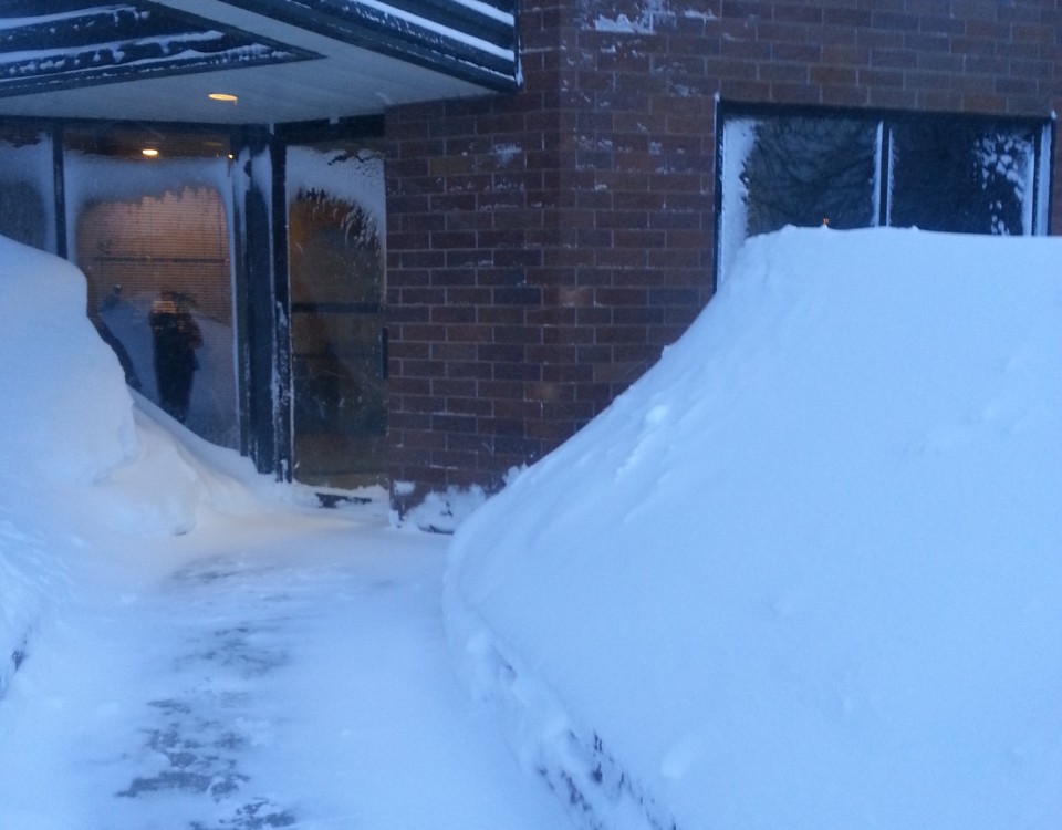 Snow drifts around the entry of The QC Group’s headquarters